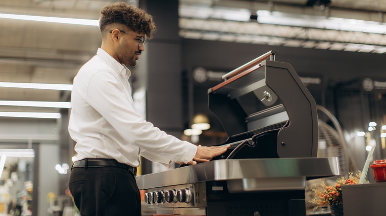 A person shopping for grill in a store