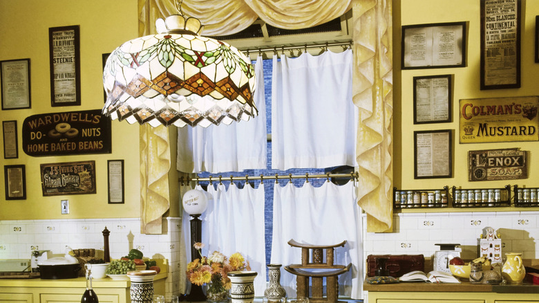 A Tiffany-style swag lamp hanging in a vintage kitchen