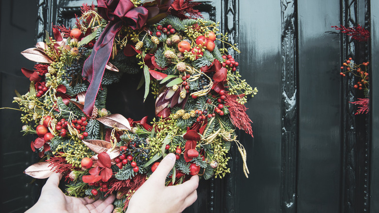 Hands reaching for a wreath