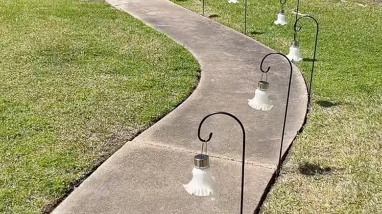 DIY solar lights along a front walkway.