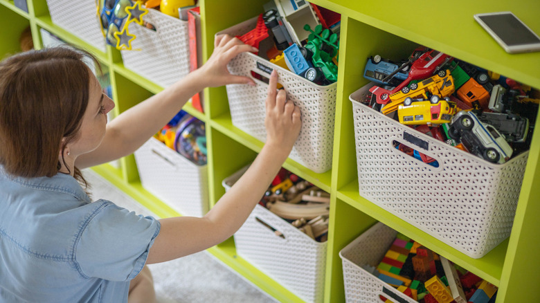 Woman looking through boxes of children's toys