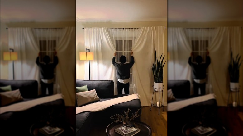 a woman closes her DIY solid-and-sheer drapery panels