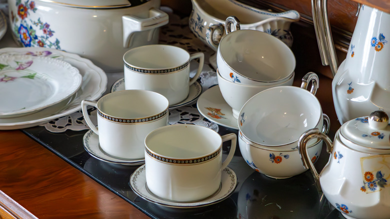 antique teacups and dishes on a table