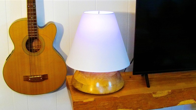 DIY lamp made from wooden bowl next to a TV