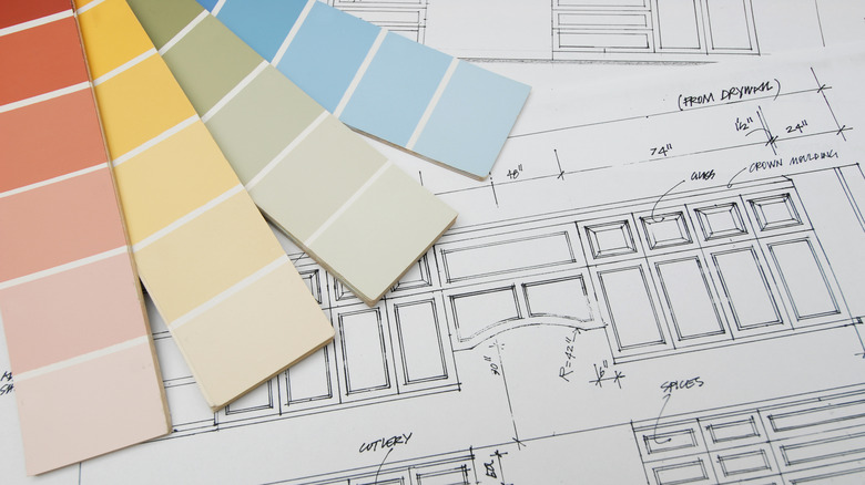 different paint color swatches with kitchen cabinet drawings in the background