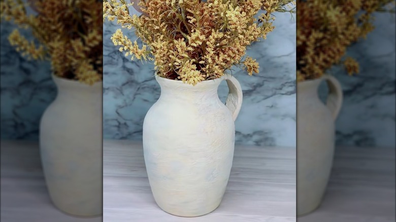 Dollar tree glass jug vase transformed into rustic clay-like planter pot with handle