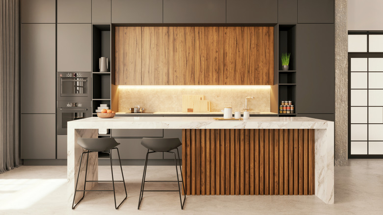 modern kitchen with medium-dark taupe matte flat front cabinets mixed with natural wood accents