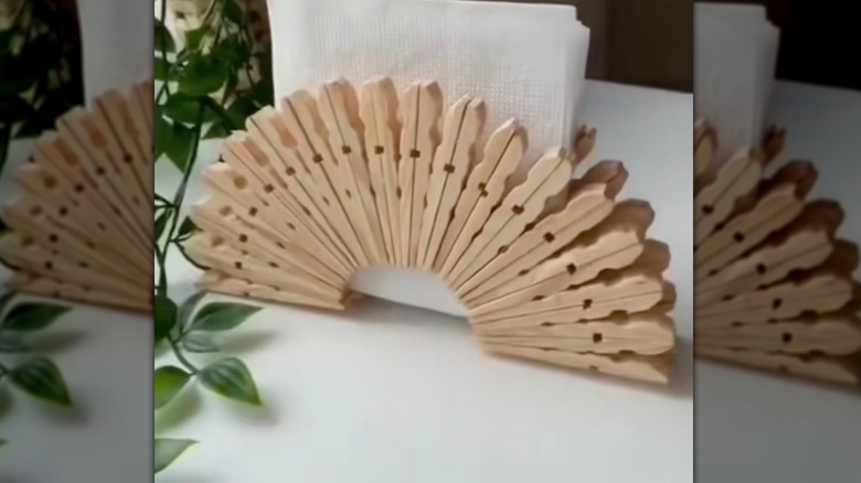 basic wooden napkin holder made from clothespins on a countertop