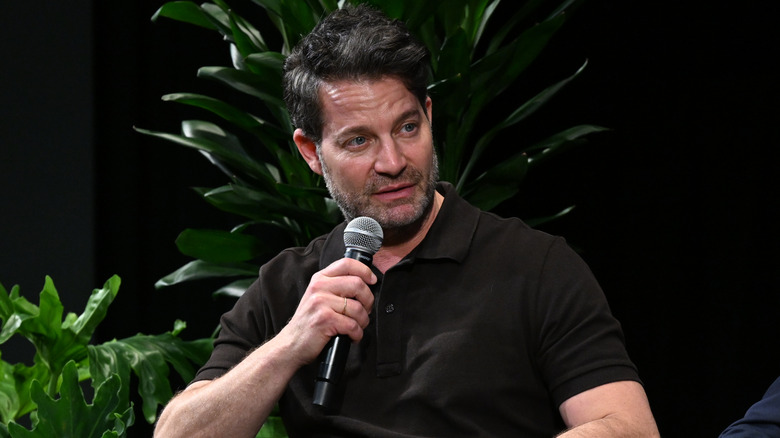 Nate Berkus holding a microphone at an event