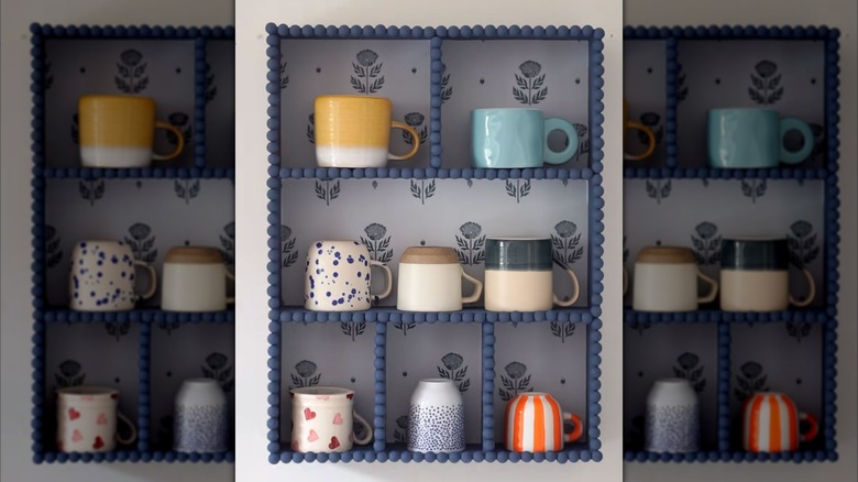 Assorted coffee mugs sit in a DIY decor IKEA hack storage solution