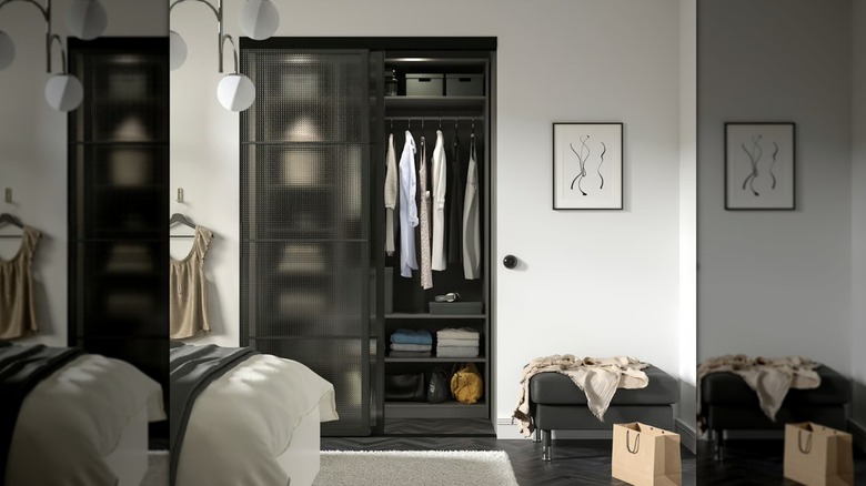 The black SKYTTA / LUNDBRÄSMA sliding door in a modern, Scandinavian room