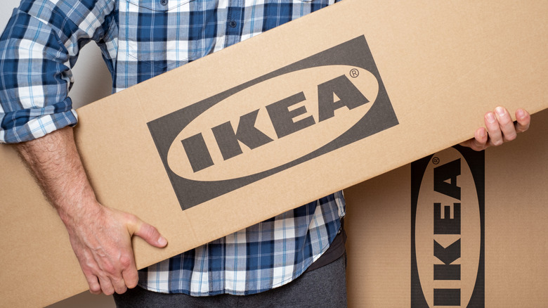 A person holding an IKEA box