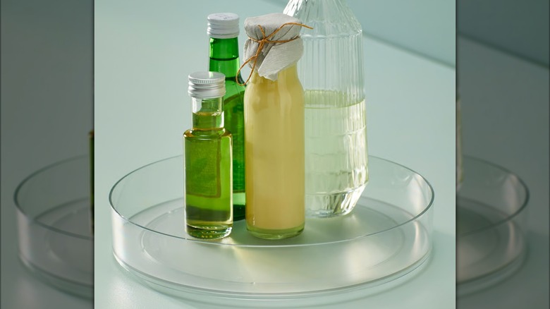Assorted glass jars sit on a clear KLIPPKAKTUS Lazy susan from IKEA