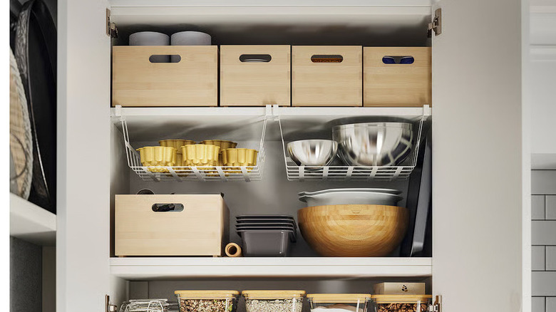 Pantry staples are stored in light wood UPPDATERA Storage boxes in a deep kitchen cabinet