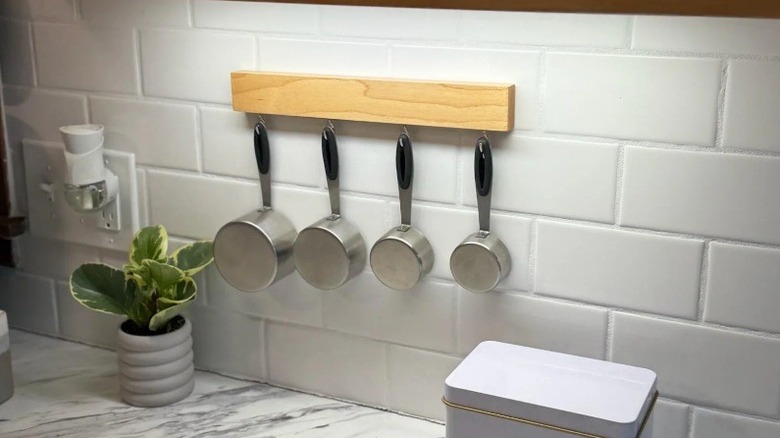 Measuring cups hanging on a board