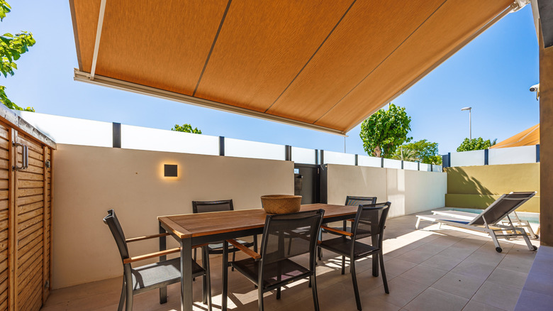 Retractable awning shading outdoor dining set