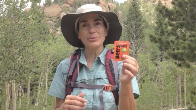 Hiker holding Ben's Insect repellent wipes