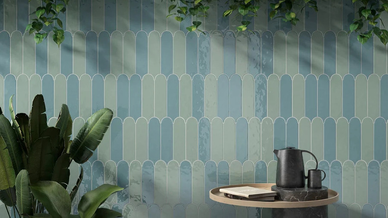 A wall with blue and green art deco tiles