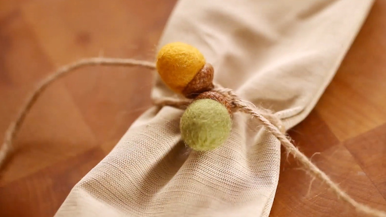 napkin rings with acorn caps, wool, and twine