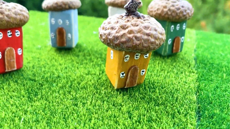 colorful fairy garden houses made with acorn caps