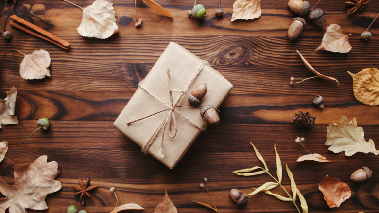 a gift wrapped with paper, twine, and acorns