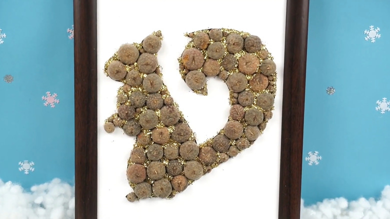 a squirrel-shaped acorn-cap wall hanging