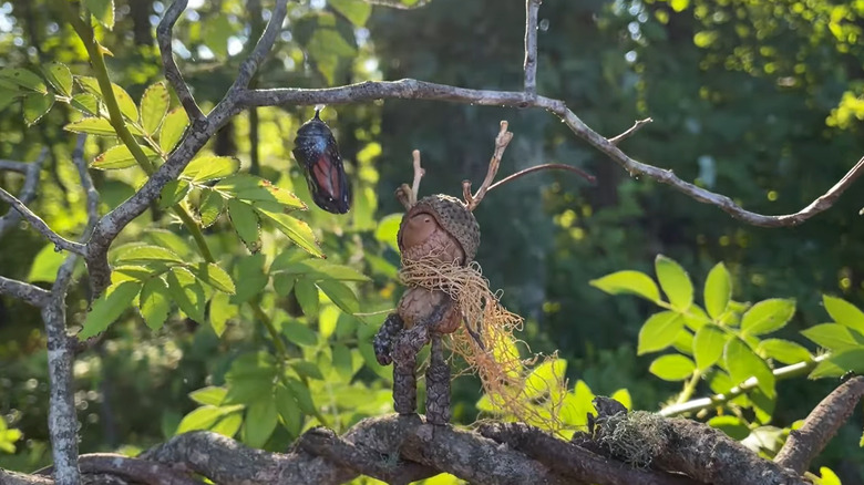a tiny doll made from acorns