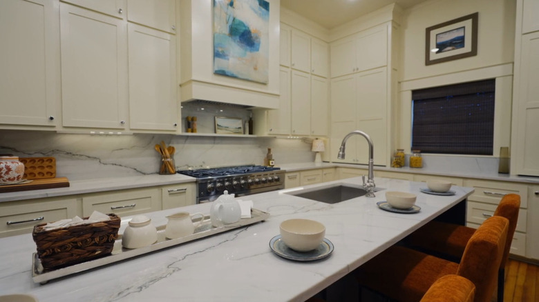 White pearl quartzite countertops in neutral kitchen