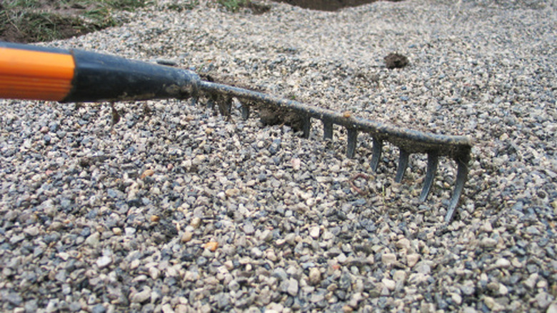 Raking out gravel.