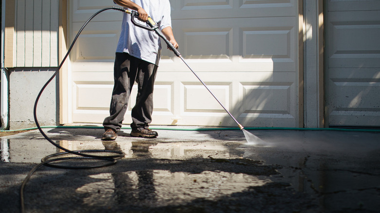 Person pressure washing their driveway.