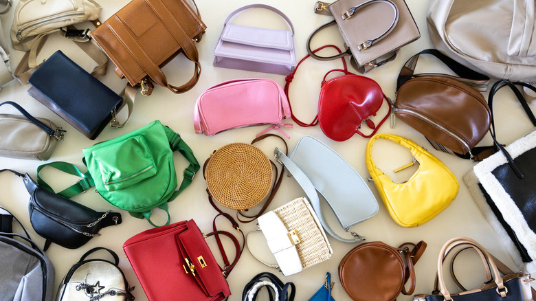 pile of various handbags on the floor
