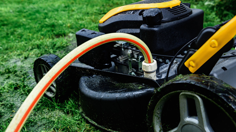Lawn mower with a hose connected to the wash port