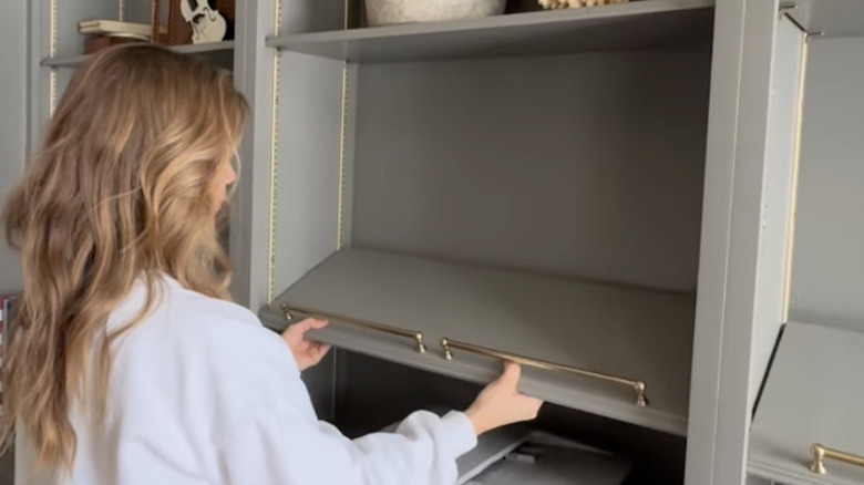 Installing adjustable bookshelves on an angle with a brass rail at the front bottom