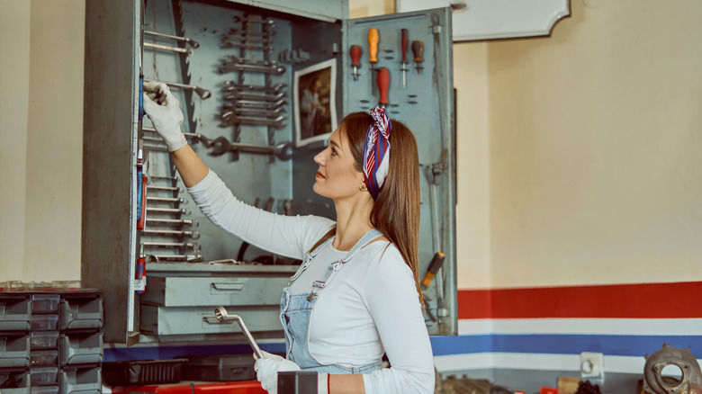 A person organizing a tool cabinet