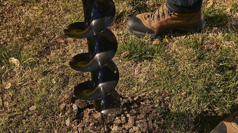 The Predator earth auger's bit biting into the ground
