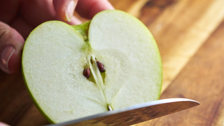 Cutting an apple to reveal seeds