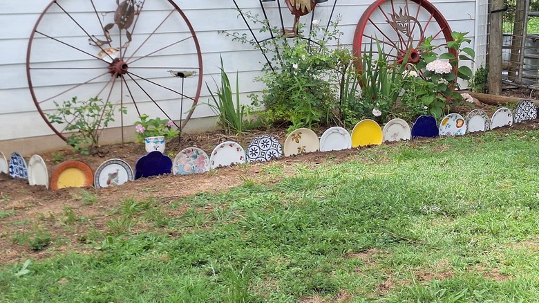 Old colorful plates turned into a garden border