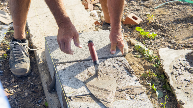 Person building with concrete blocks