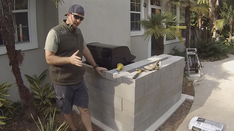 Man standing in front of DIY grill counter