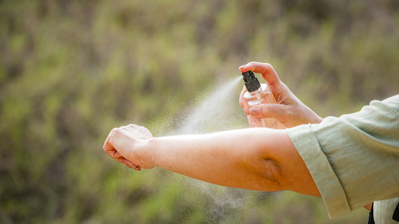 Person spraying self with homemade tick spray