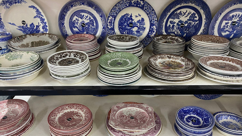 Thrift store shelves full of vintage dishes