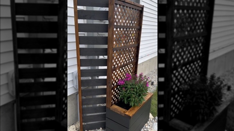 A screen to cover utility boxes, made with lattice and pallet wood