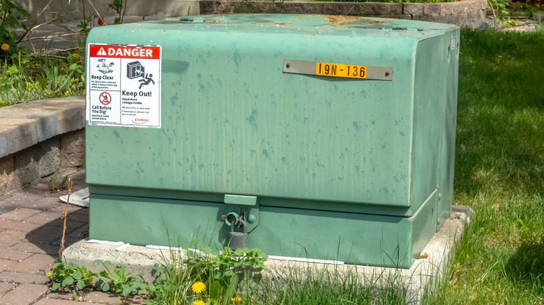 A typical electrical transformer in a yard