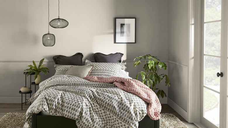 a bedroom with walls painted in Behr's Contemplation color