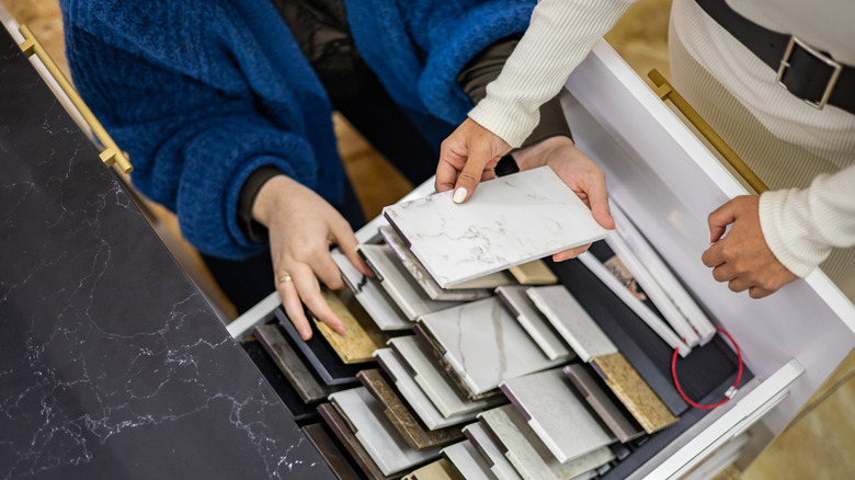 Two people looking together at kitchen countertop samples