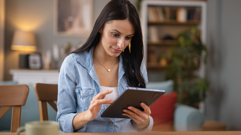 Woman reading an article on a tablet