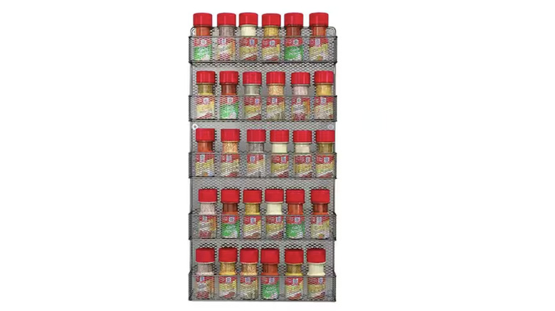 A five-row organization rack holding red-capped spice bottles
