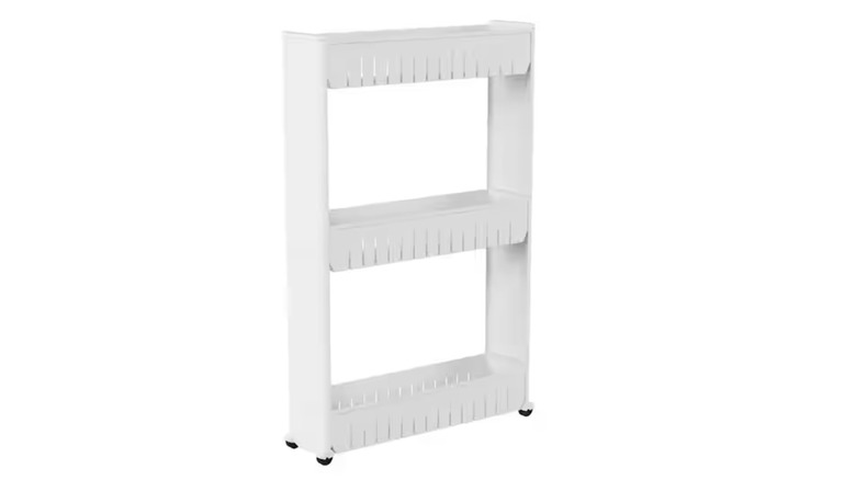 A white three-tier organizer sitting on wheels