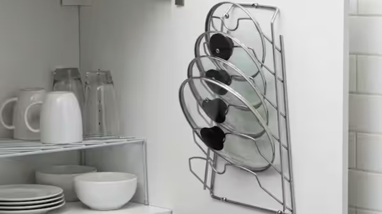 A pot lid organizer rack mounted inside a cabinet door