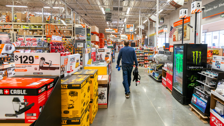 A shopper walking through the aisles of Home Depot